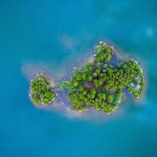 Drone picture of a small, green island